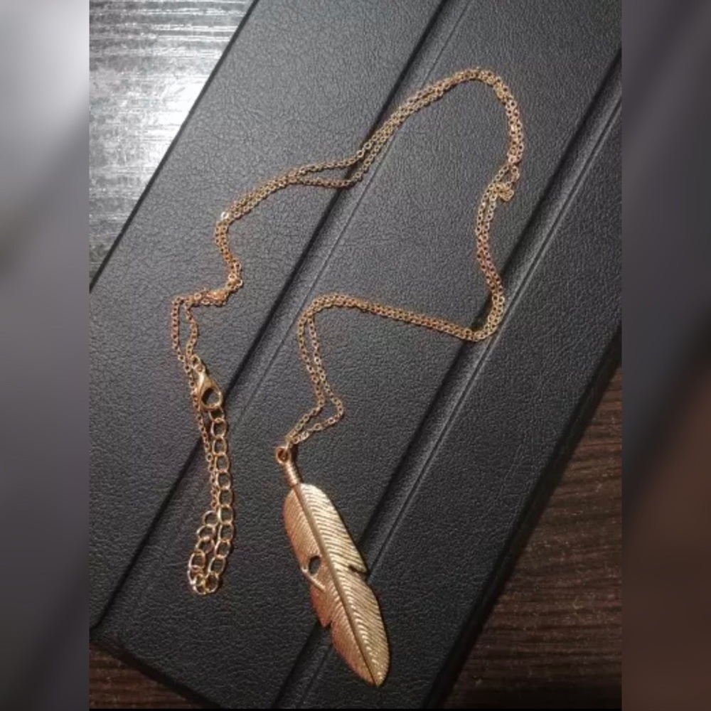 Long gold feather pendant necklace